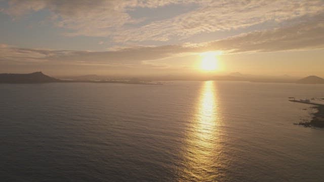 Sunset over the ocean with distant islands