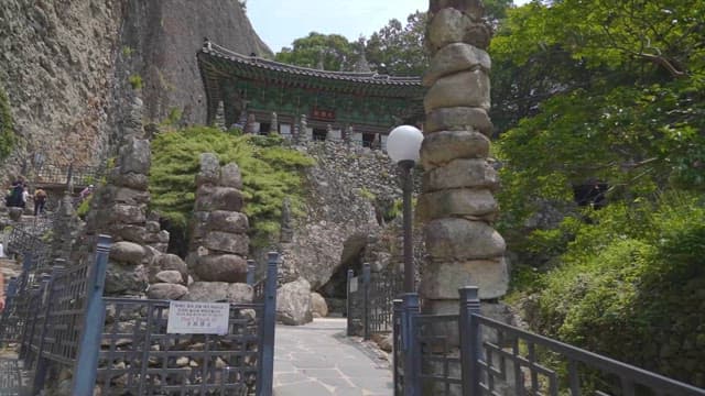 Serene Temple Entrance with Stone Stairs and Statues