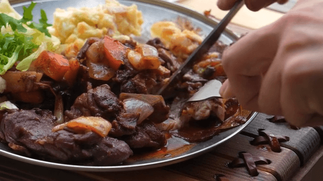 Dining scene of enjoying a delicious meat and vegetable stir-fry on a plate