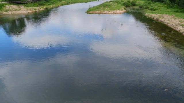 Serene river with distant mountains