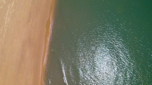 Beach with Glimmering Sea under the Sun