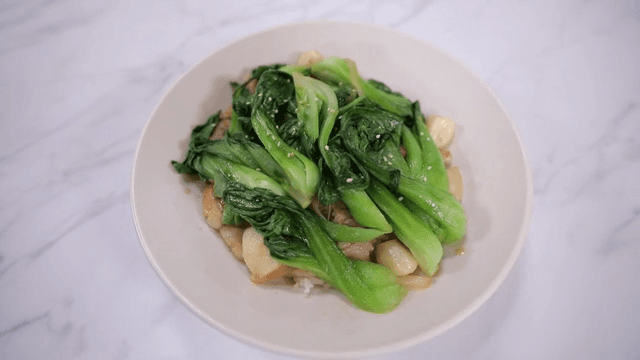 Plate of stir-fried bok choy and pork with garlic