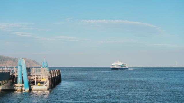 Ferry Approaching Dock on Sunny Day