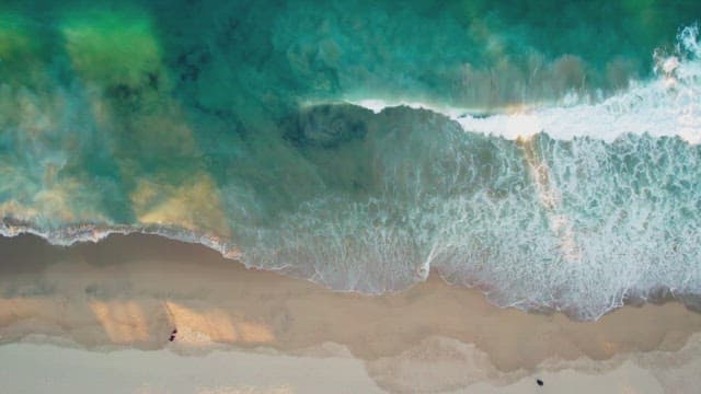 Waves crashing on a sandy beach
