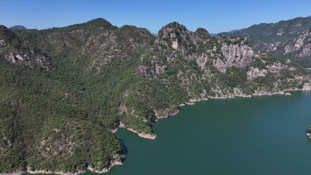 Tranquil Lake Between Lush and Majestic Mountains