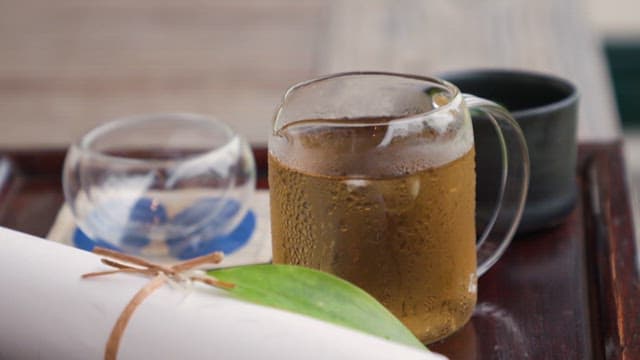 Cold tea and paper neatly placed on a wooden tray