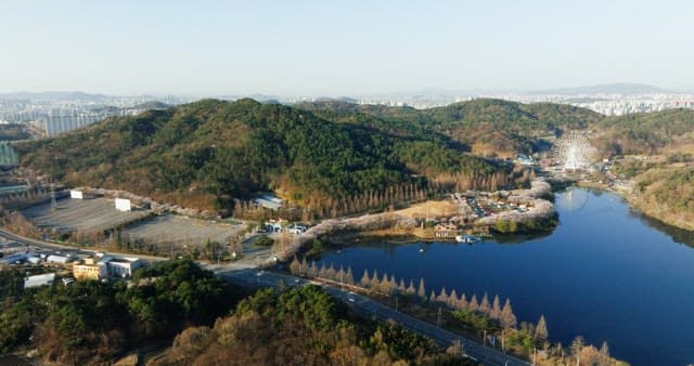 Hilly landscape with ferris wheel