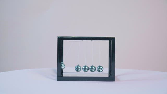 Newton's Cradle Demonstration on Table