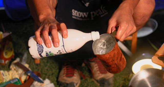 Pouring Makgeolli into Ice-filled Cup Outdoors