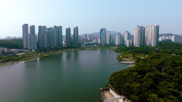 Aerial view of a city with high-rise buildings and a lake