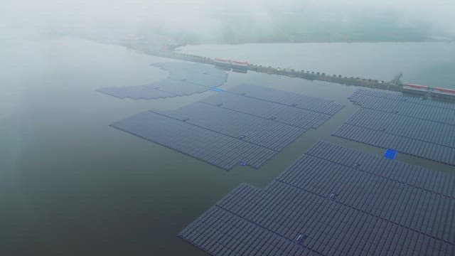 Floating solar panels on a misty river