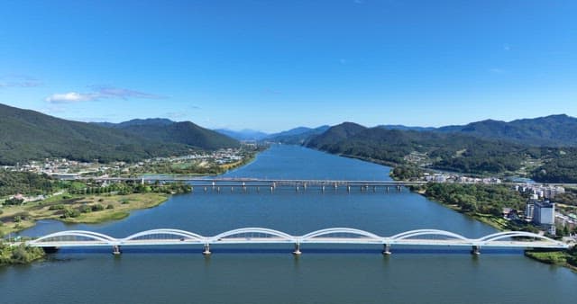 Wide river with bridges and mountains
