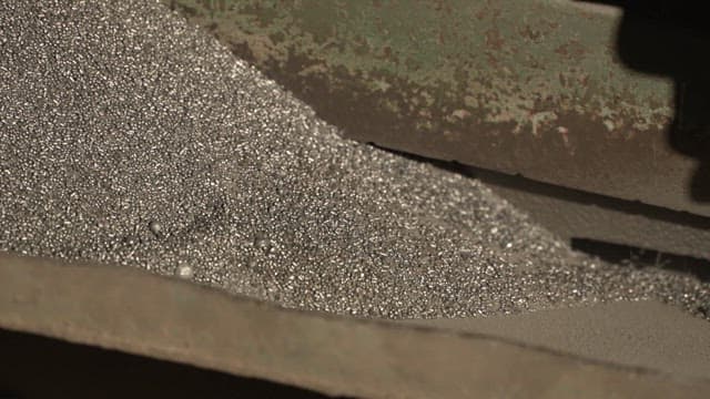 Metallic particles being processed