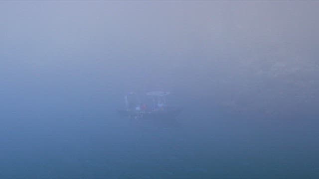 Security Guard Rescuing Shipwrecked People on a Foggy Coast