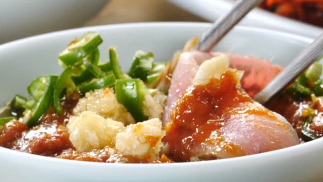 Fresh raw fish dipped in ssamjang with vinegar at a sushi restaurant
