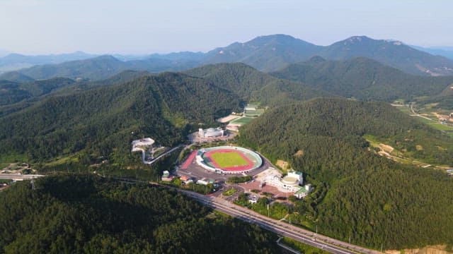 Stadium nestled among lush green mountains
