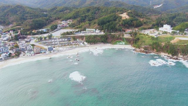 Coastal town with scenic beach and hills