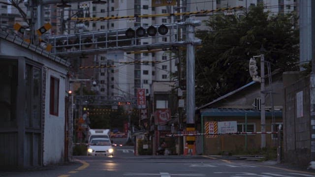 Quiet Street at Dusk with Passing Vehicle