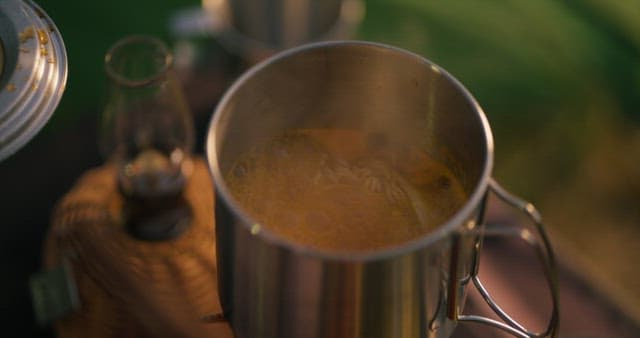 Preparing Noodles in a Metal Pot Outdoors