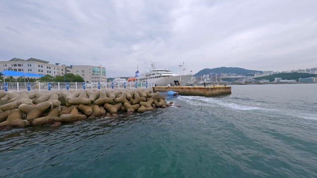 Speedboat Approaching a Coastal City Dock