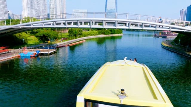 Boat Cruising under the Bridge in the Park 