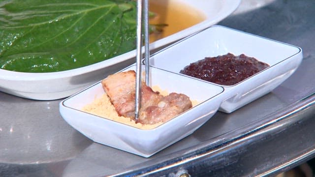 Pork belly dipped in bean flour served on perilla leaf