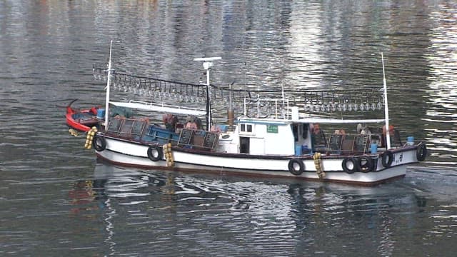 Fishing boat traveling on calm waters