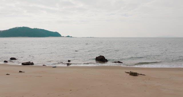 Beach with Distant Hills Beyond the Sea
