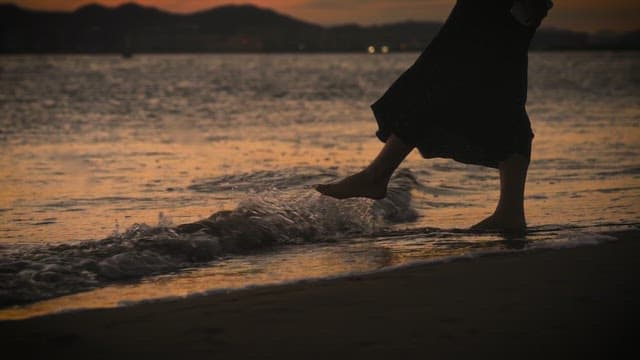 Strolling Barefoot on the Beach at Sunset