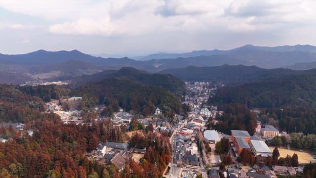 Scenic view of a town surrounded by mountains
