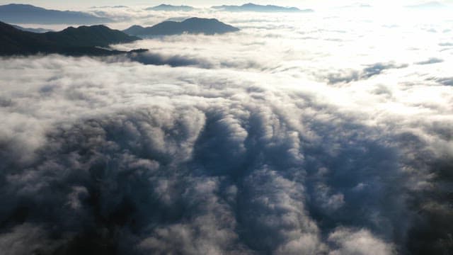 Vast clouds over mountains