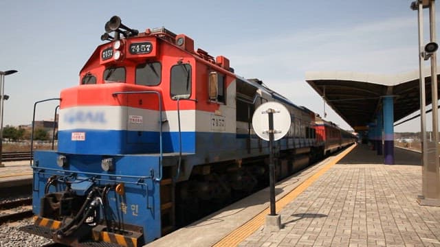 Leaving Train at a Sunny Railroad Station Platform