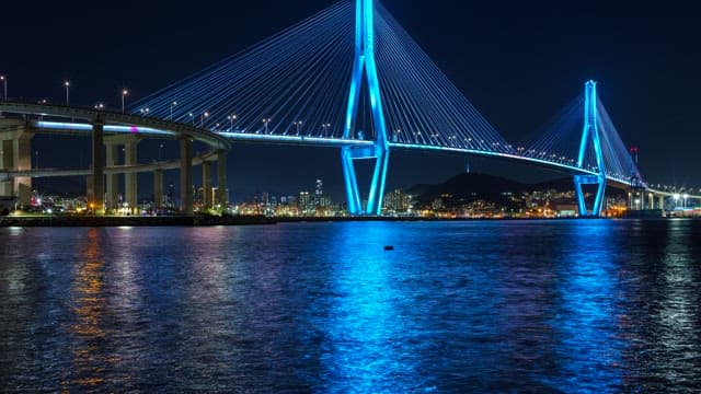 Colorful illuminated Busanhangdaegyo Bridge at night with cityscape