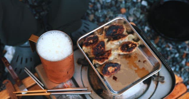 Enjoying Cooked Dumplings and Beer Outdoors