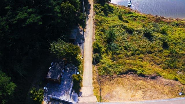 Small boat anchored on a riverside with lush forests