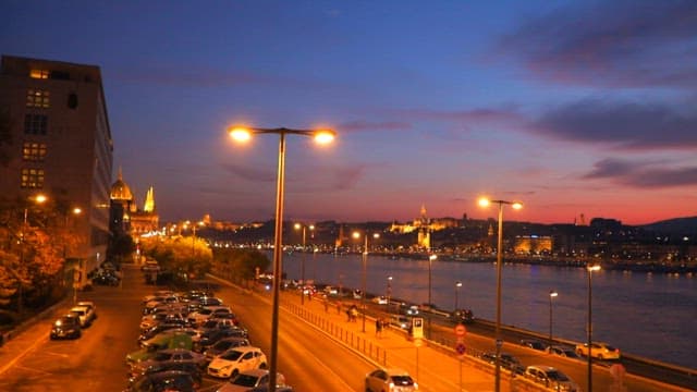 Evening cityscape by the river with sunset