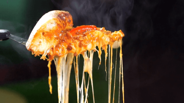 Cheese Chicago pizza slice being lifted with melted cheese