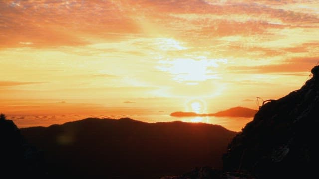 Vibrant sunset over the mountains and ocean