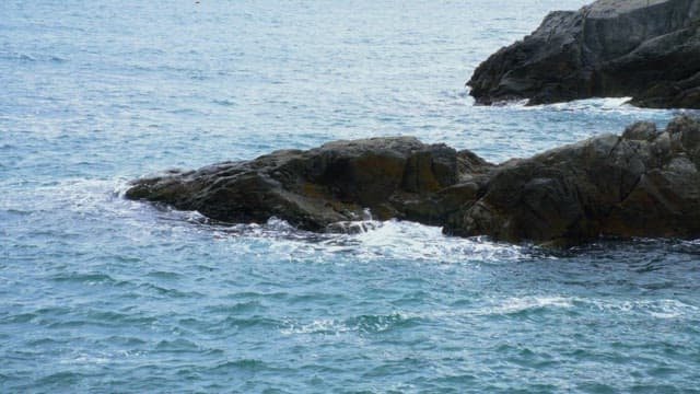 Waves crashing against the coastal rocks