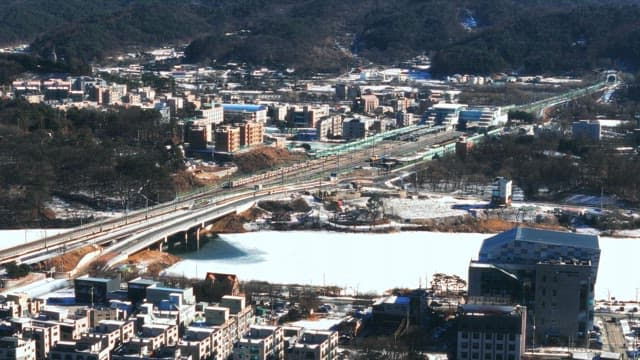 Winter Cityscape with Frozen River and Trains