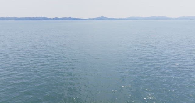 Vast ocean with distant mountains