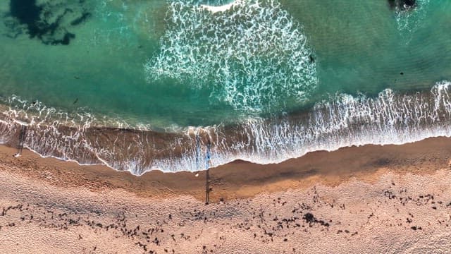 Waves crashing on a sandy beach