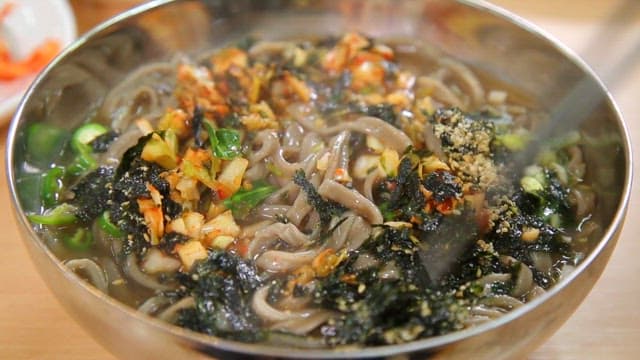 Appetizing buckwheat noodles topped with seaweed and sesame seeds