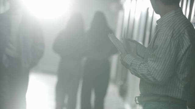 Person Handing out Papers to Passers-by