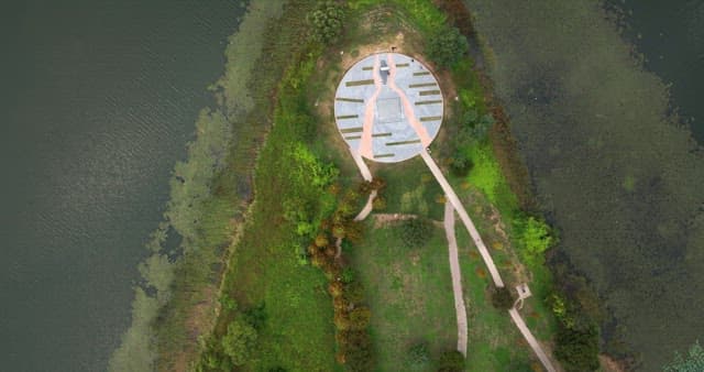 View of a lush green park with paths