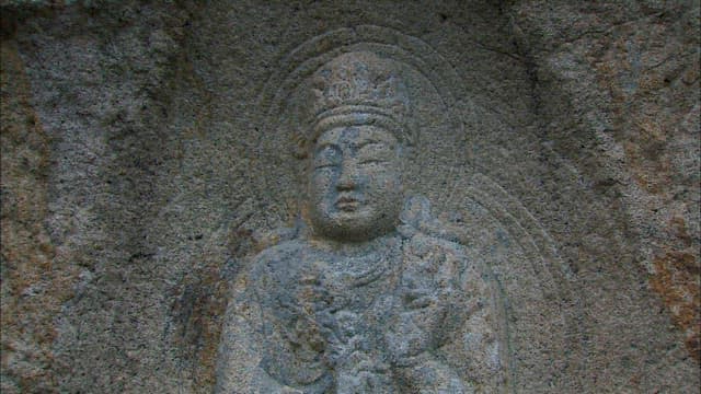 Buddha rock with carved Buddha statue