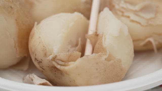 Peeling Boiled Potatoes on a Plate