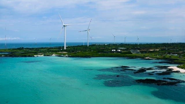 Coastal Wind Turbines Overlooking Emerald Waters