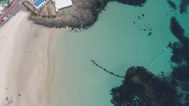 Coastal village with green fields and ocean