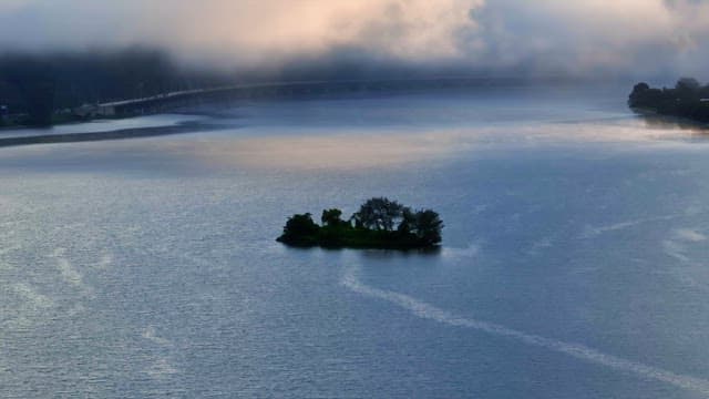 Small island in a misty river
